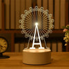 A white acrylic LED night light shaped like the Eiffel Tower is displayed on a wooden surface.