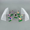Football birthday cake toppers featuring soccer players and field decor with white pyramid structures