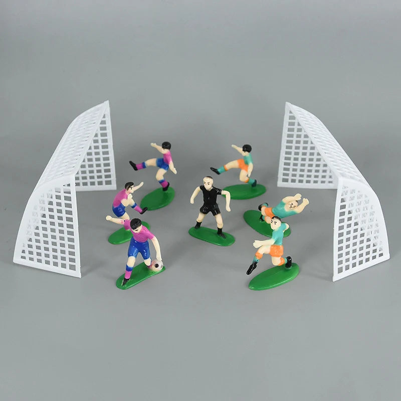 Football birthday cake toppers featuring soccer players and field decor with white pyramid structures