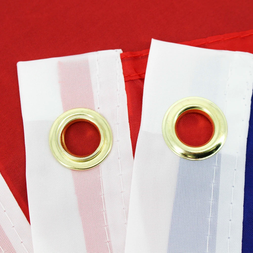 White and red striped fabric banner with gold grommets against a red background.