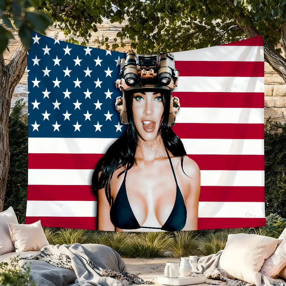 A woman wearing a helmet stands in front of a pink USA flag tapestry with red and white stripes.