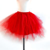 A bright red tulle tutu skirt displayed on a mannequin.