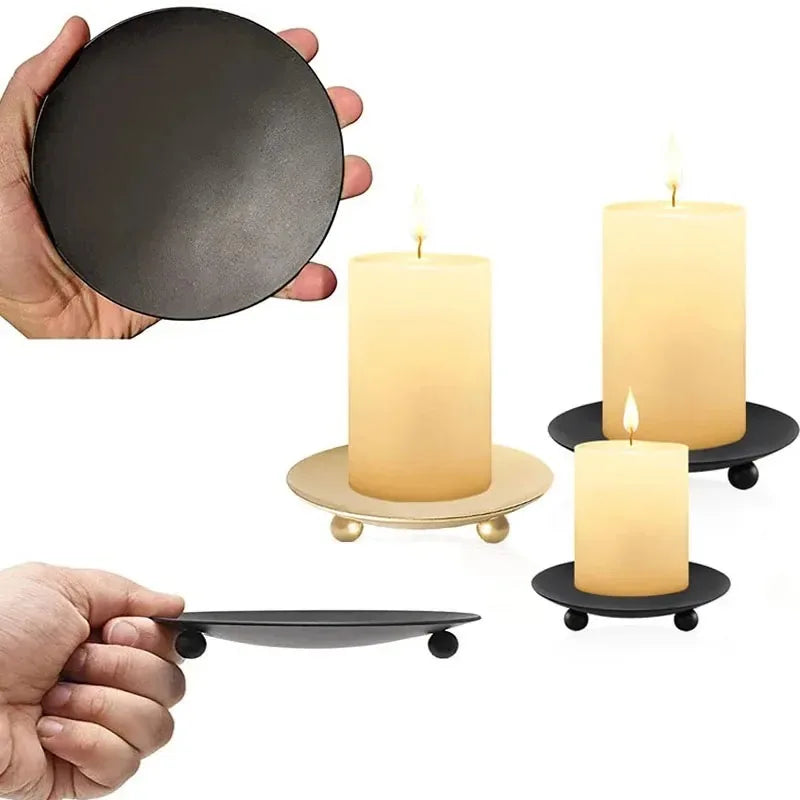 Elegant iron candle holder tray with gold accents featuring a black disc and a tall pillar candle.