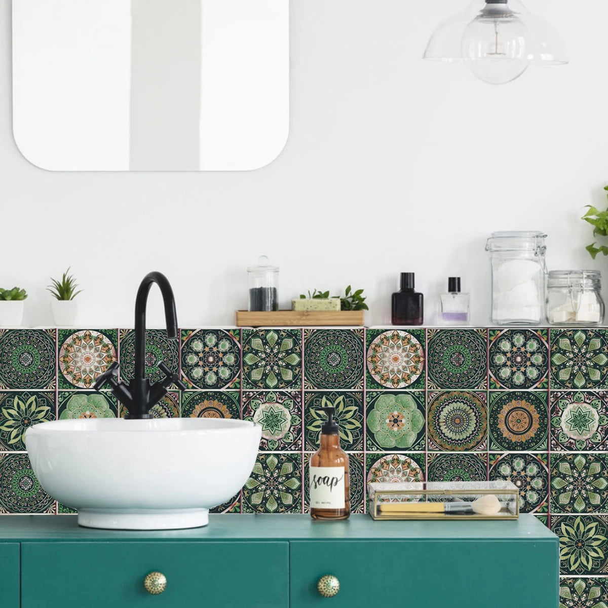 A white ceramic sink bowl is set against a green tiled backsplash in a kitchen or bathroom setting.