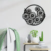 Black metal flower wall art set featuring a wreath design displayed on a white wall.
