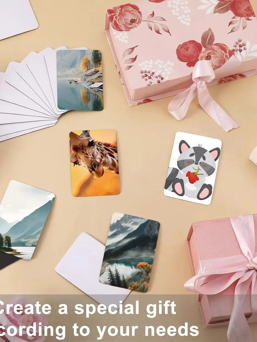 A collection of photo cards and a pink gift box with a ribbon on a beige background.