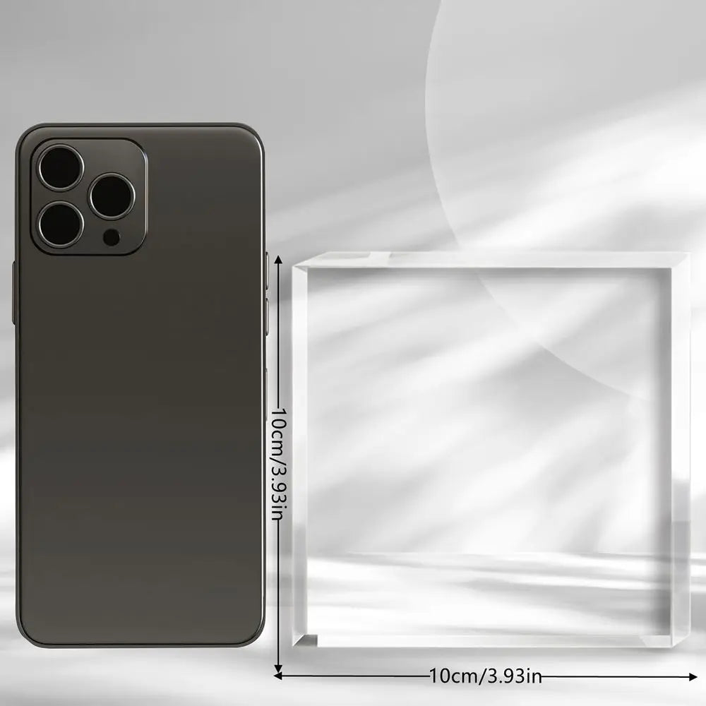 A dark gray smartphone is shown next to a clear acrylic box, illustrating the size of the phone.