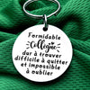 Silver keychain with a white disc engraved with the French quote: Formidable collègue dur à quitter et impossible à oublier