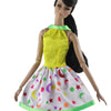 A handmade doll dress gown featuring a yellow bodice and a white skirt with colorful stars and moons.