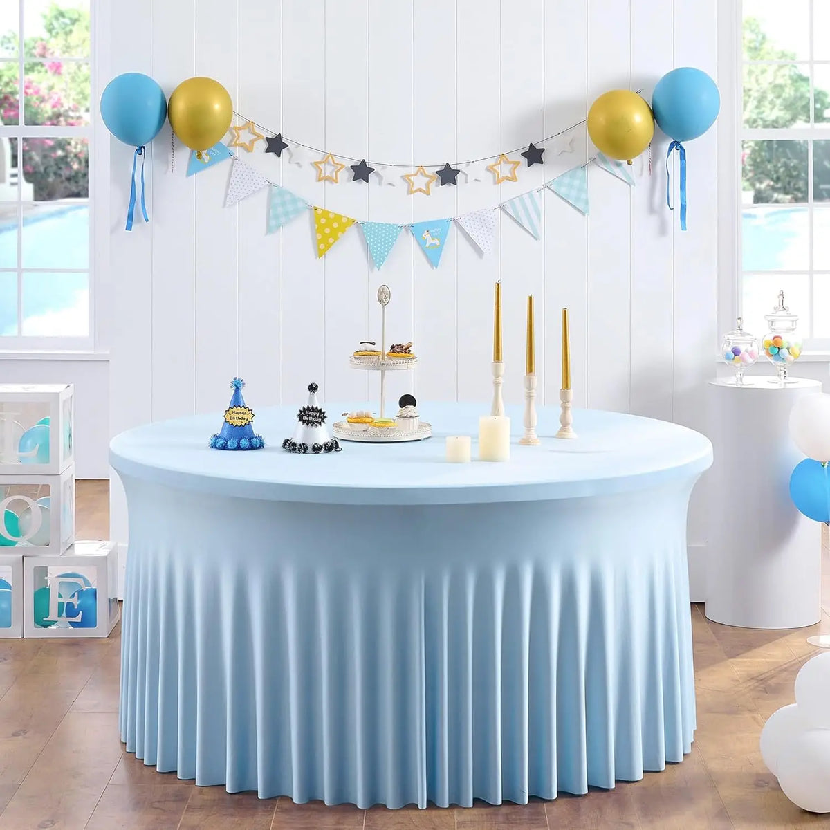 Light blue stretch spandex round tablecloth with pleats set for a party or event.