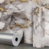 Roll of marble pattern self-adhesive wallpaper featuring gray and gold veining against a marbled background