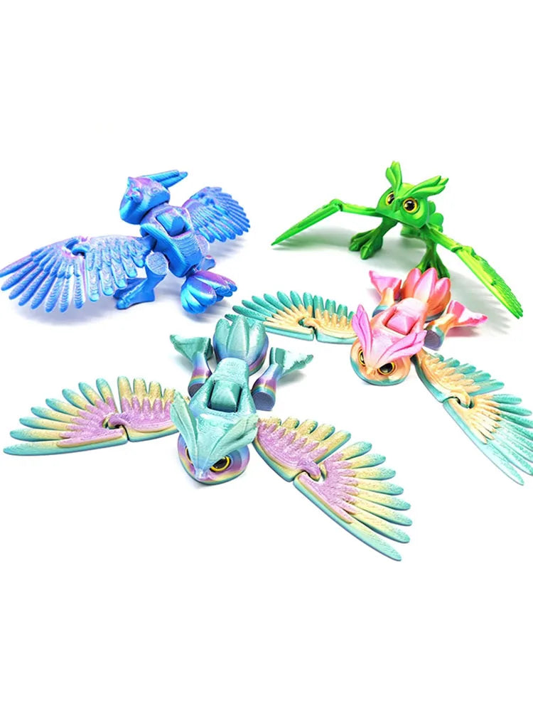 A set of three articulated 3D printed owl figurines in shades of blue, green, and pink.