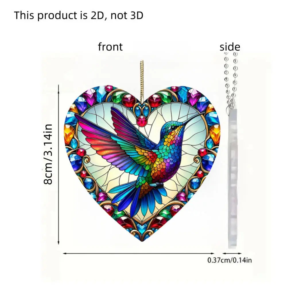 A 2D acrylic hummingbird heart-shaped ornament with iridescent colorful wings hanging from a chain.