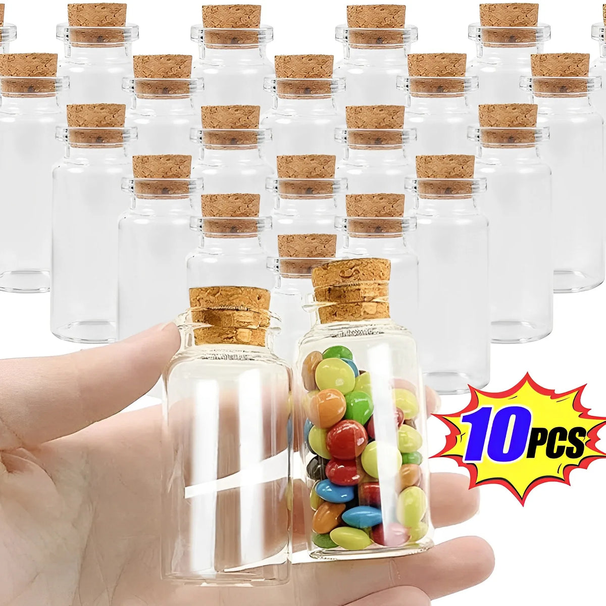 A hand holds a glass vial filled with colorful beads and cork stoppers, surrounded by multiple empty glass vials.