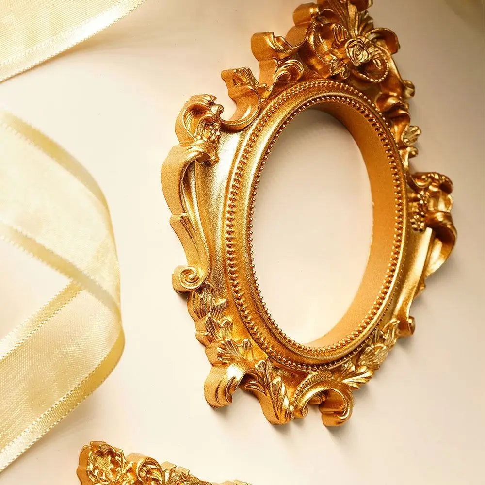 A vintage gold DIY shadow box frame with ornate carvings, displayed against a light background.