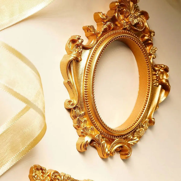 A vintage gold DIY shadow box frame with ornate carvings, displayed against a light background.