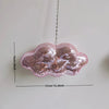 Pink retro disco glass mirror ornament shaped like a cloud, hanging by a chain.