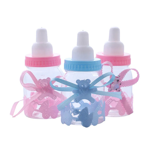 Three clear baby bottle shaped candy favor boxes with pink and blue accents for baby showers