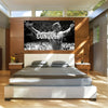 A motivational gym flag banner featuring Arnold Schwarzenegger conquering a crowd, displayed above a modern bed.
