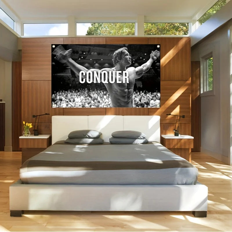 A motivational gym flag banner featuring Arnold Schwarzenegger conquering a crowd, displayed above a modern bed.