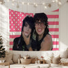 A portrait of Jake Webber and Johnnie Guilbert featuring a pink and white striped tapestry wall hanging.