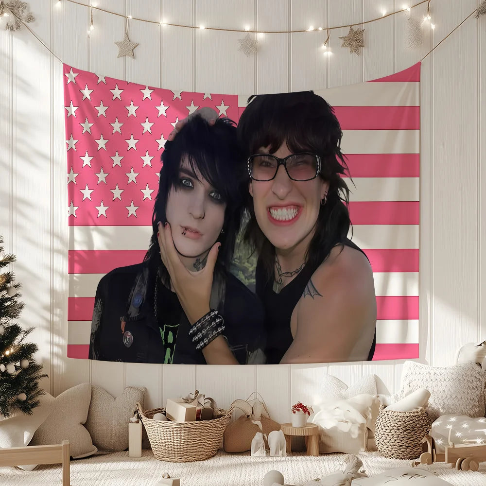 A portrait of Jake Webber and Johnnie Guilbert featuring a pink and white striped tapestry wall hanging.