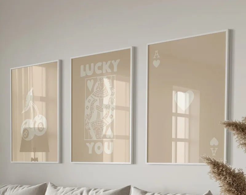 Three framed art prints featuring the words lucky you and a heart design in sepia tones