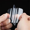Hands hold a clear double-sided adhesive tape, showing its transparent and flexible nature.