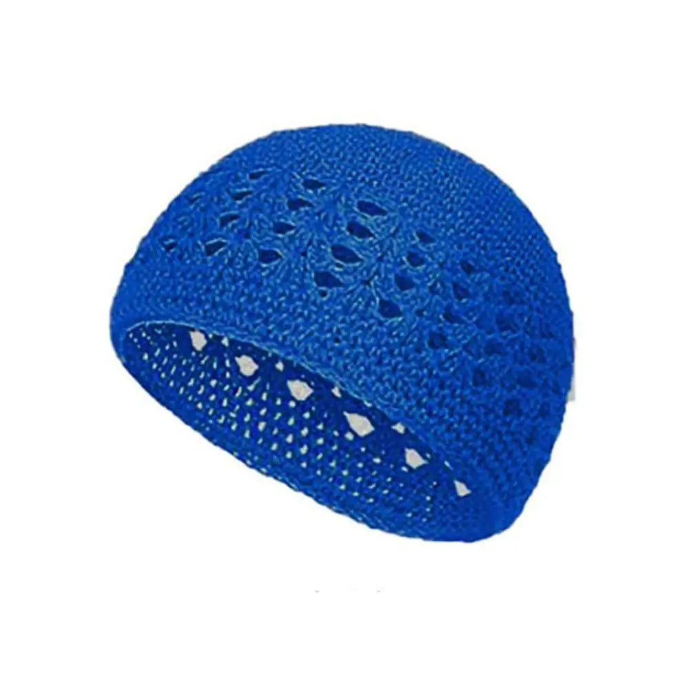 A bright blue handmade crochet beanie hat with an openwork pattern.