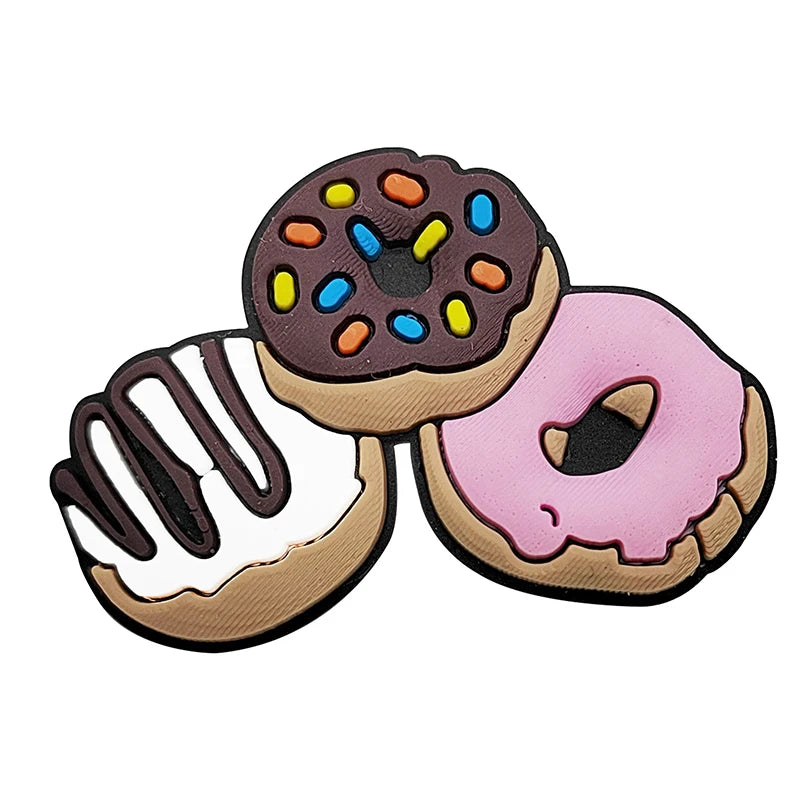 A set of three colorful doughnut charms in brown, purple, and pink.
