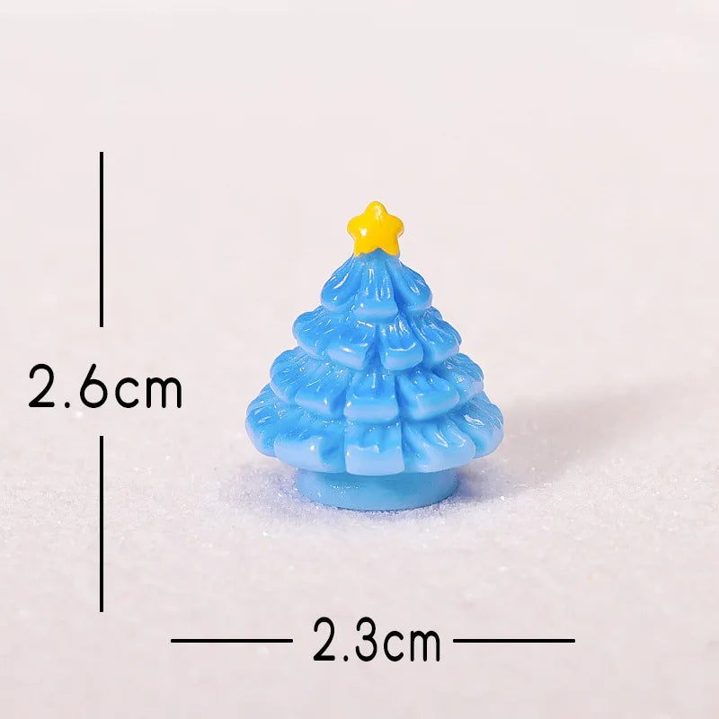 A small, light blue resin Christmas tree charm with a yellow star topper, shown against a white background.