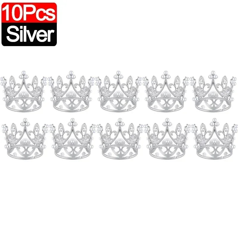 Ten silver crown cake topper decorations arranged in a row.