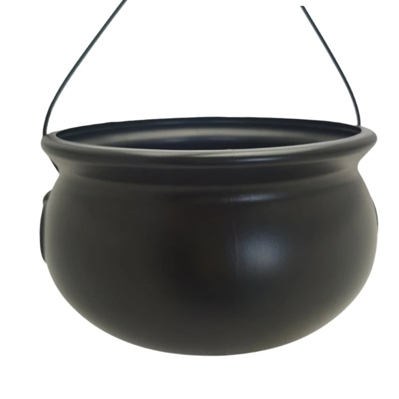 A black witch cauldron candy bowl hanging by a thin wire.