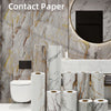 Rolls of marble contact paper in various shades and patterns displayed against a marbled wall background.