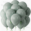 A cluster of sage green latex balloons floating against a white background.
