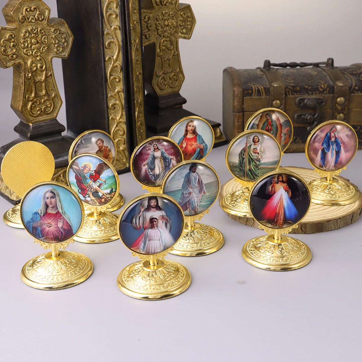 A collection of retro Catholic tabletop ornaments featuring painted figures in gold-toned frames.