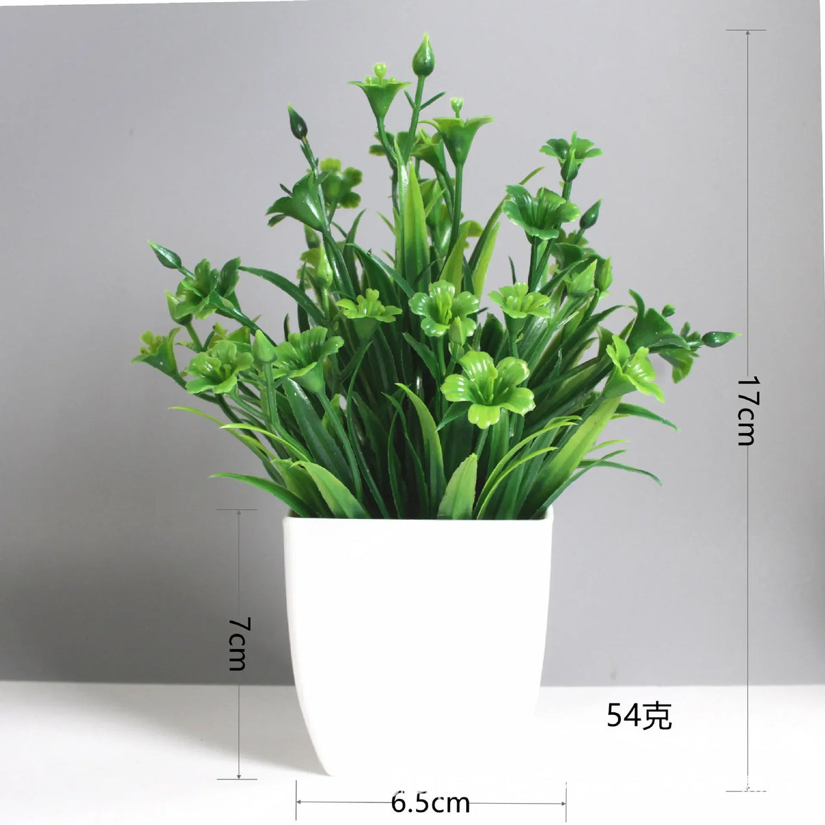 A potted artificial bonsai plant with green eucalyptus accents in a white rectangular pot.