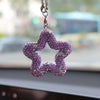 A purple rhinestone star charm hanging from a silver chain.