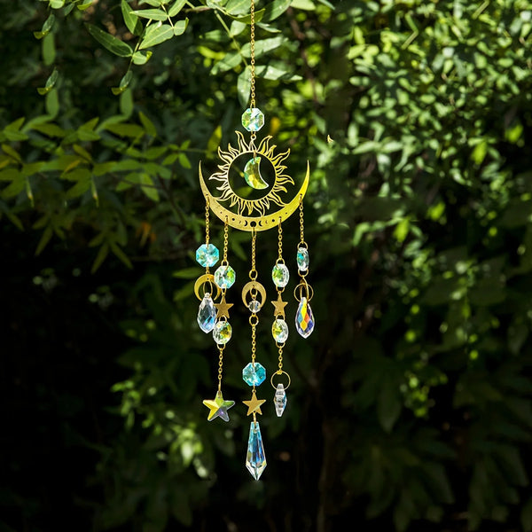 A hanging golden crystal wind chime featuring a crescent moon and sun design with various colored crystals and charms.