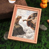 A framed art print featuring a painting of a lion and a man on a rock against a cloudy sky
