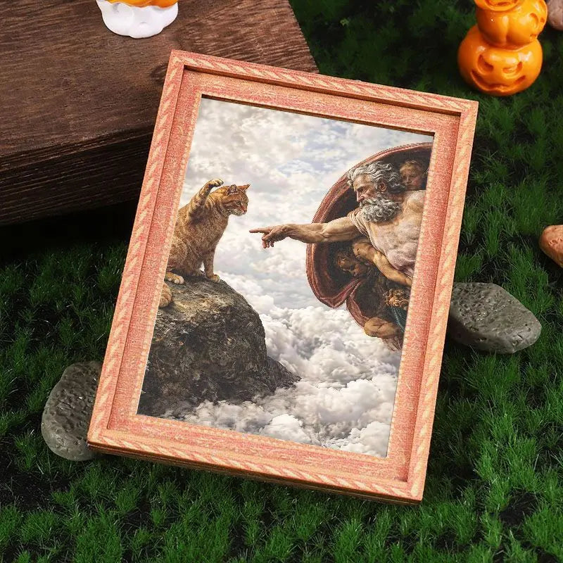 A framed art print featuring a painting of a lion and a man on a rock against a cloudy sky, displayed on green grass.
