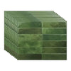 A stack of rectangular, textured green peel and stick backsplash tiles viewed from the side.