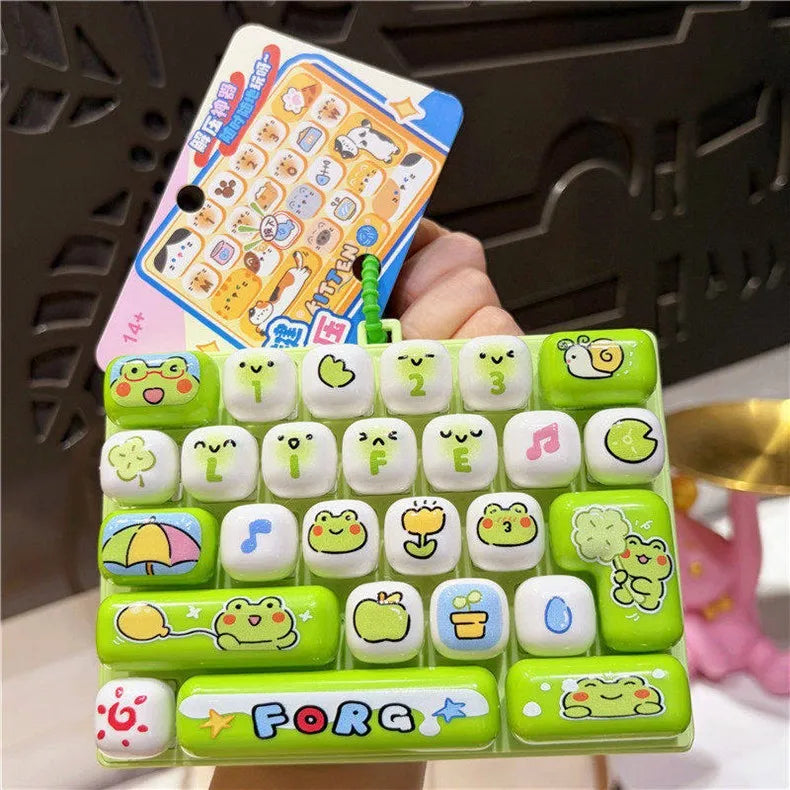 A set of green and white cartoon animal keycap fidget toys packaged in a plastic case.