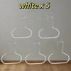 Five white hat organizer racks hanging against a light gray wall.