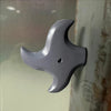 A gray 3D axe fridge magnet with a pointed head is shown against a light background.