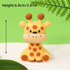 A yellow and orange spotted animal cake topper resembling a baby giraffe or cub.