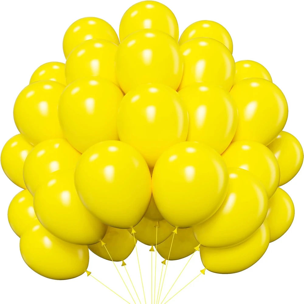 A cluster of yellow latex balloons floating upwards.
