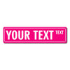A pink rectangular sign with the text YOUR TEXT and a smaller word TEXT on the right.