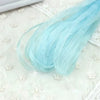 Light blue decorative fishtail yarn ribbon strands laid on a white textured surface
