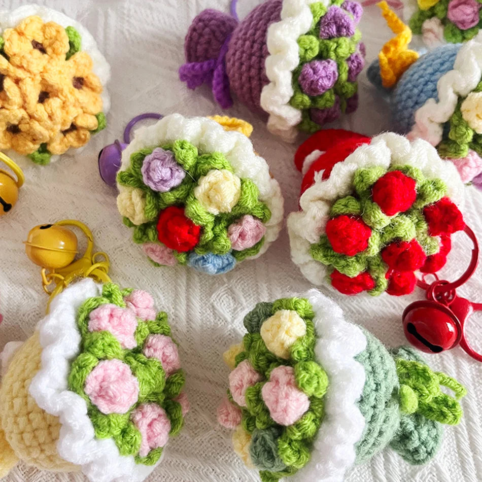 A collection of handmade crochet flowers in various colors and textures, arranged for a bouquet keychain.